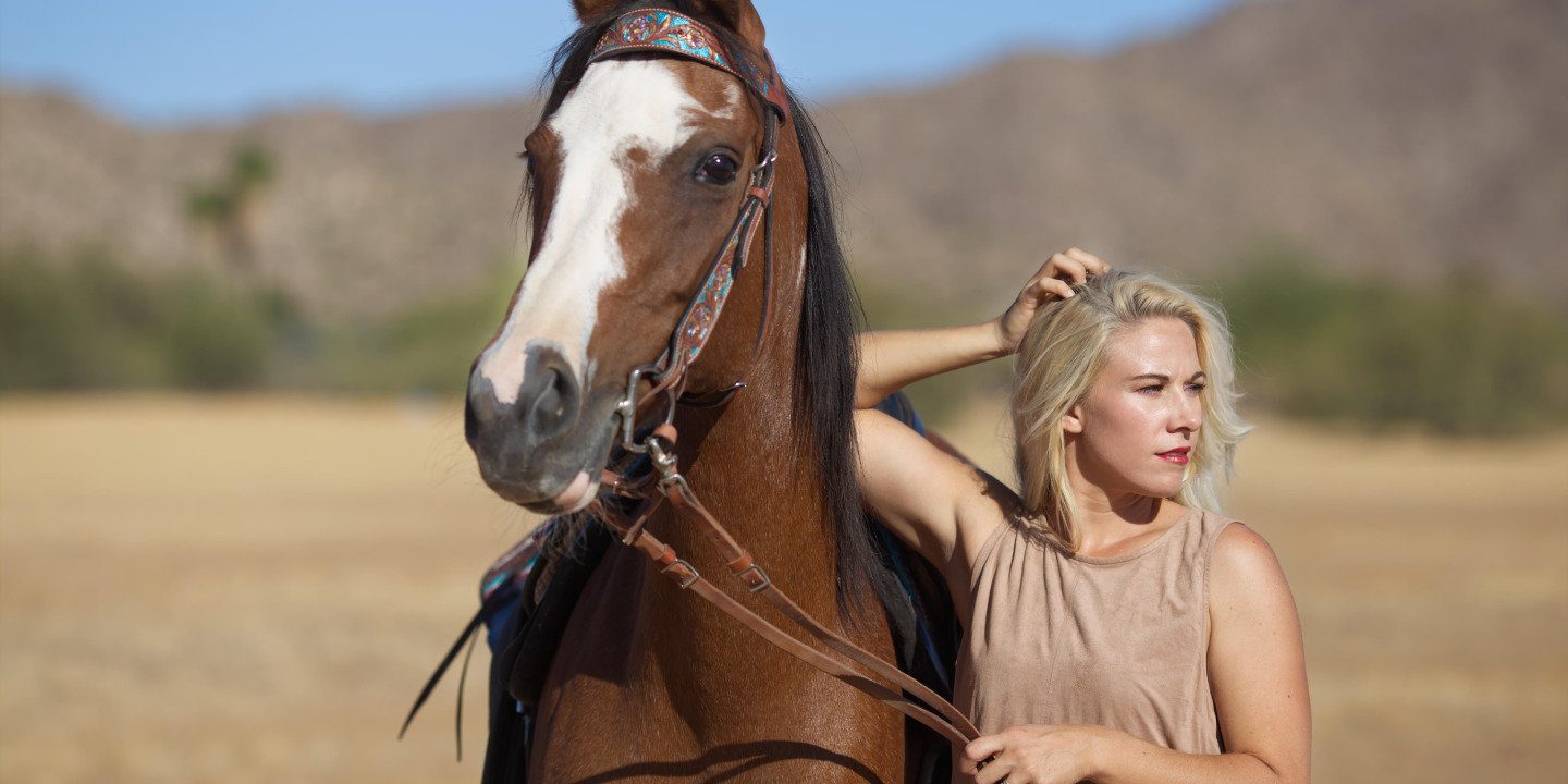 High school senior photographed posing with her horse in Casa Grande Arizona
